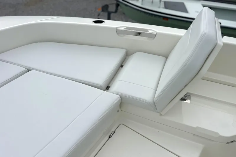 Slide: The Image of 2024 Pathfinder 2400 TRS boat interior with white cushioned seating. - 22