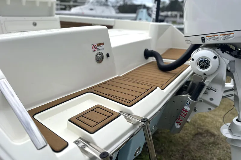 Slide: The Image of 2024 Pathfinder 2400 TRS boat with teak deck and outboard motor detail. - 4