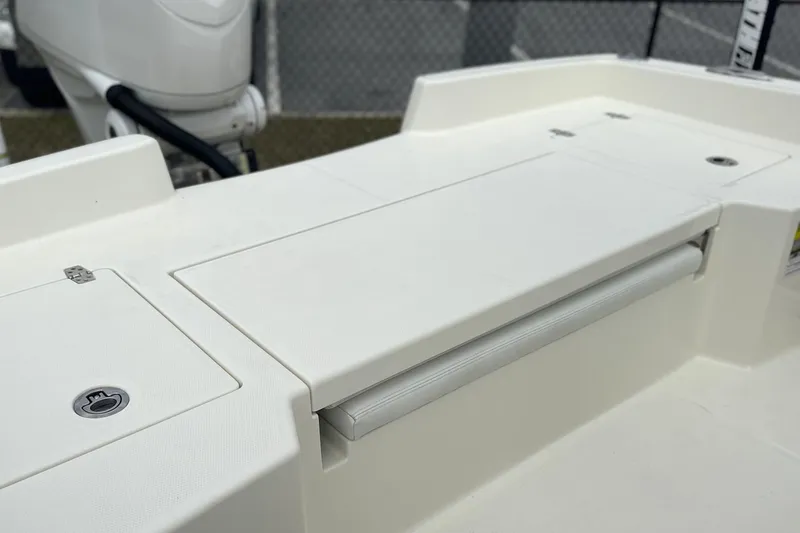 Slide: The Image of 2024 Pathfinder 2400 TRS boat deck with storage compartment and motor detail. - 8