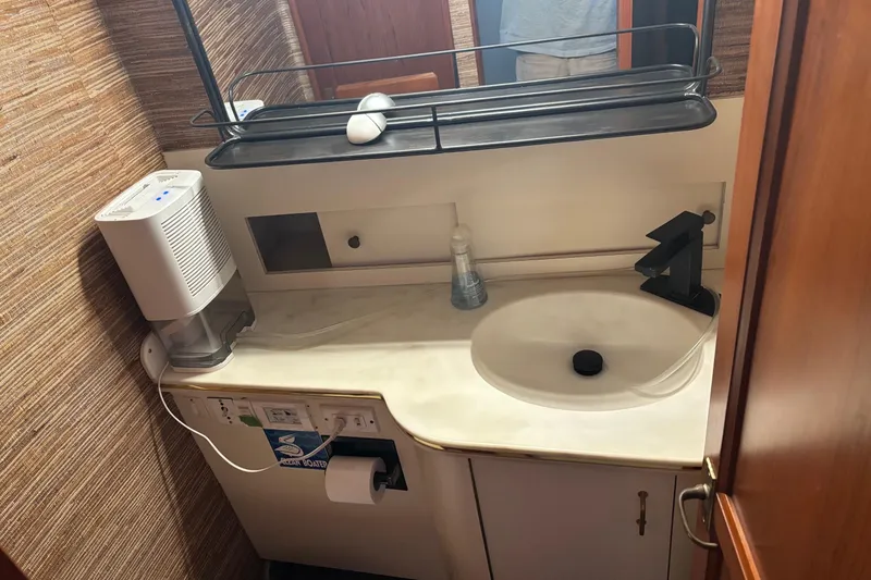 Slide: The Image of Bathroom sink area in 1989 Ocean 48 Motor Yacht with modern fixtures and accessories. - 10