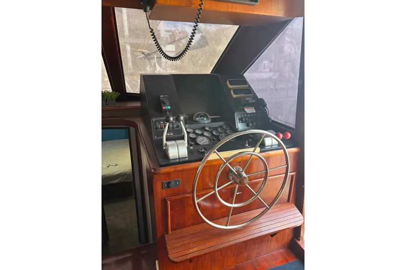Slide: The Image of 1989 Ocean 48 Motor Yacht helm with wooden dashboard and steering wheel. - 11