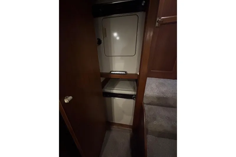 Slide: The Image of Laundry area inside 1989 Ocean 48 Motor Yacht with stacked washer and dryer. - 14