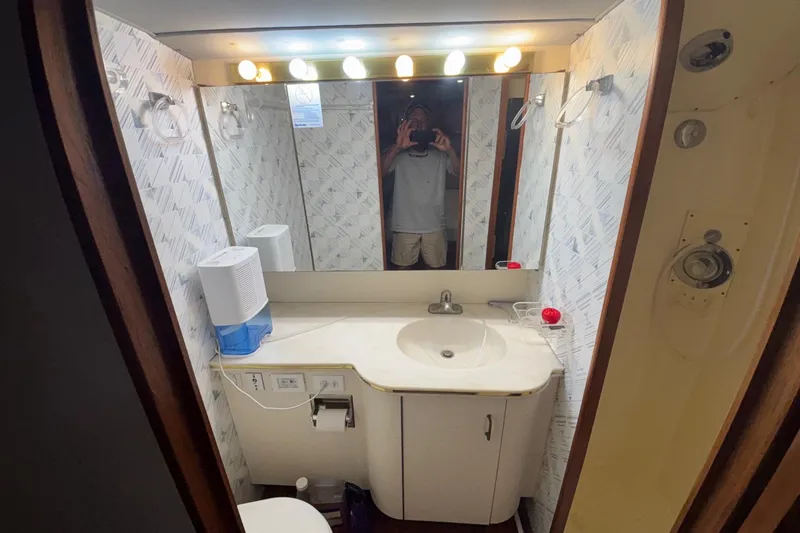 Slide: The Image of Bathroom interior of 1989 Ocean 48 Motor Yacht with sink, mirror, and lighting. - 16