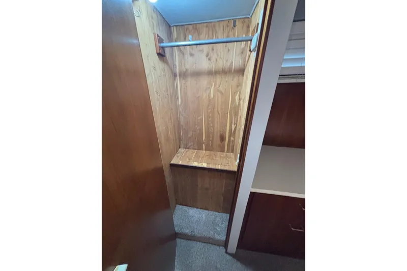 Slide: The Image of Wooden closet interior on 1989 Ocean 48 Motor Yacht, featuring hanging rod and shelf. - 20