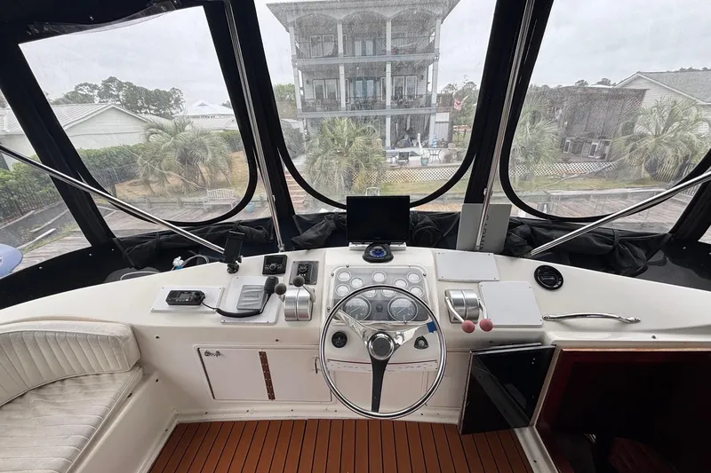 Slide: The Image of Cockpit view of 1989 Ocean 48 Motor Yacht with steering wheel and control panel. - 22