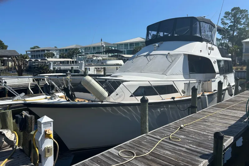 Slide: The Image of 1989 Ocean 48 Motor Yacht docked at marina under clear blue sky. - 3