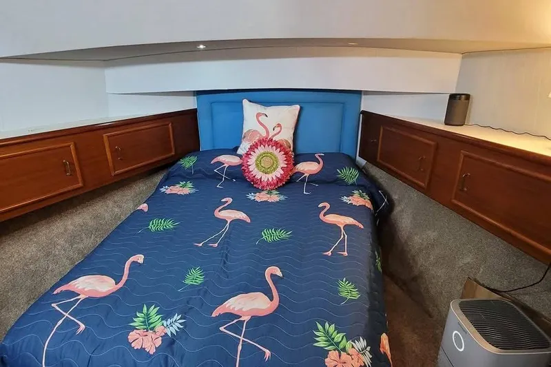 Slide: The Image of Cozy bedroom in 1989 Ocean 48 Motor Yacht with flamingo-themed bedding. - 31