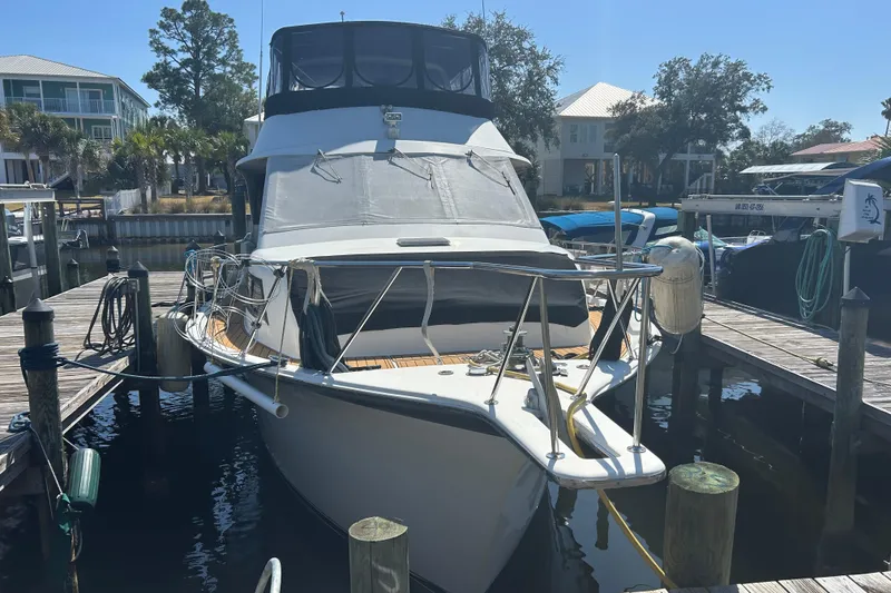 Slide: The Image of 1989 Ocean 48 Motor Yacht docked at marina under clear blue sky. - 4