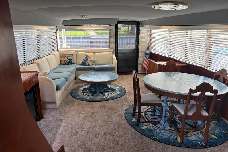 Slide: The Image of Luxurious interior of a 1989 Ocean 48 Motor Yacht with elegant seating and dining area. - 8