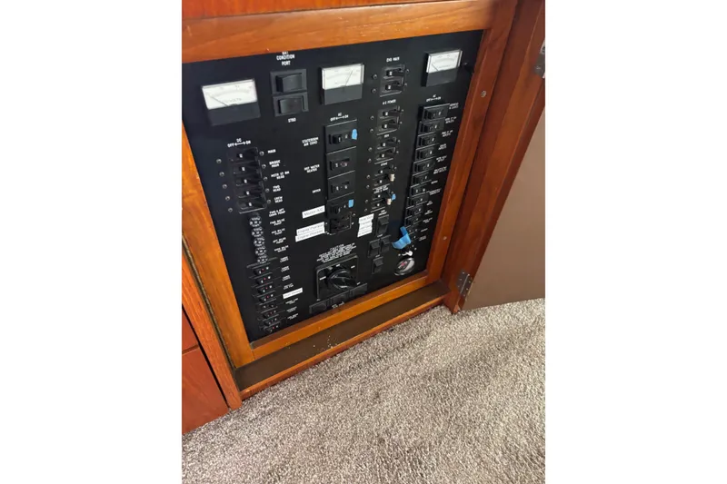 Slide: The Image of Electrical panel of a 1989 Ocean 48 Motor Yacht, featuring switches and meters. - 9