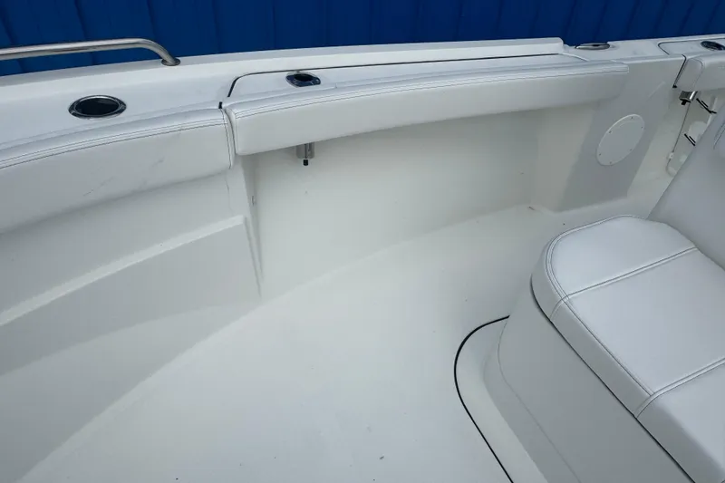 Slide: The Image of 2026 Parker 180 Coastal boat interior with white seating and blue backdrop. - 10