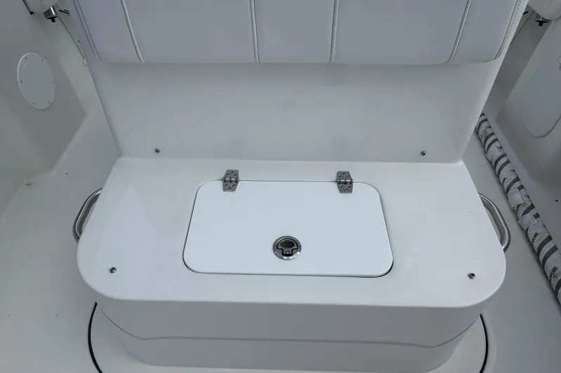 Slide: The Image of White seating area with storage compartment on 2026 Parker 180 Coastal boat. - 11