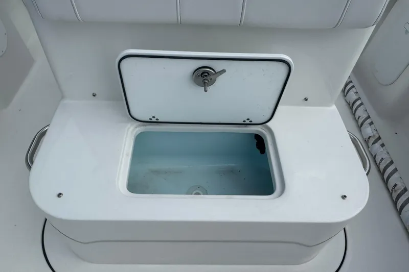 Slide: The Image of Livewell compartment on a 2026 Parker 180 Coastal boat, featuring a secure latch. - 12