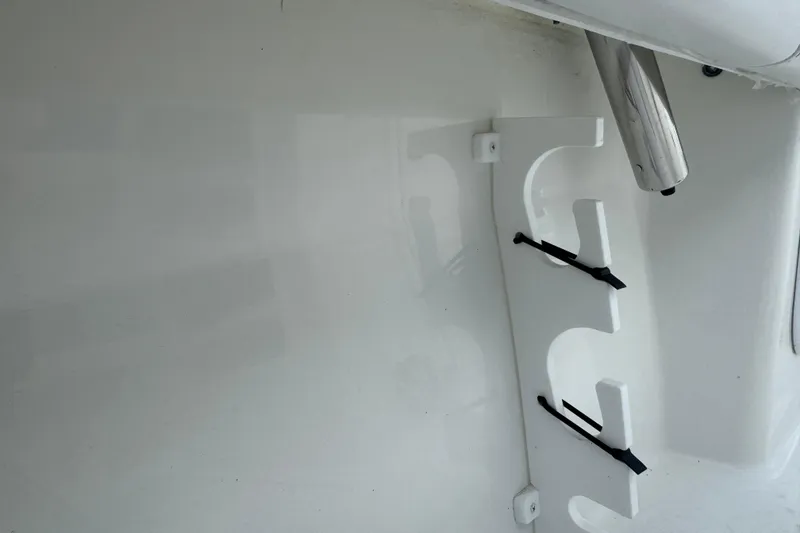 Slide: The Image of 2026 Parker 180 Coastal boat interior with rod holder and stainless steel fixture. - 13