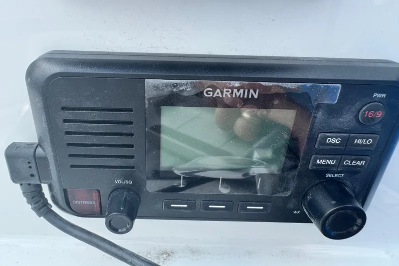 Slide: The Image of Garmin marine radio on Parker 180 Coastal, 2026 model, featuring distress and control buttons. - 16
