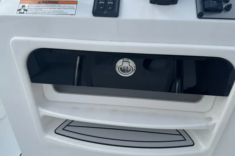 Slide: The Image of Control panel of 2026 Parker 180 Coastal boat with warning label and switches. - 19