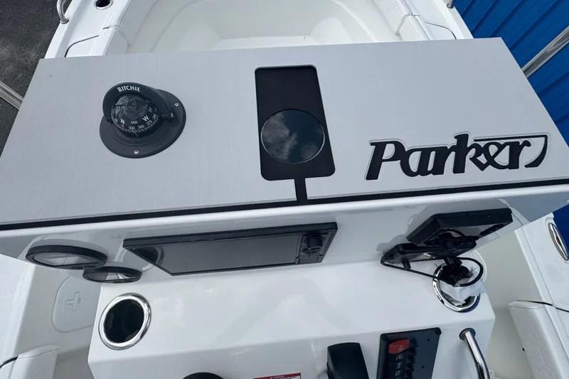 Slide: The Image of 2026 Parker 180 Coastal boat dashboard with compass and control panel. - 24