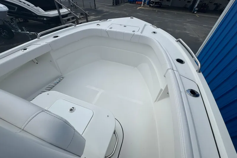 Slide: The Image of 2026 Parker 180 Coastal boat interior, featuring spacious white seating and storage compartments. - 6