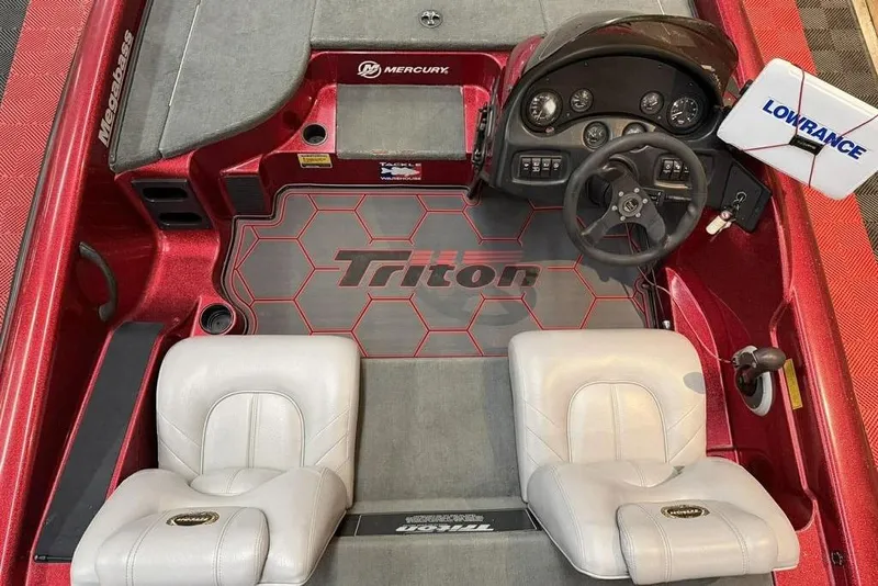 Slide: The Image of 2003 Triton Tr-186 boat interior with steering wheel, seats, and Lowrance equipment. - 4