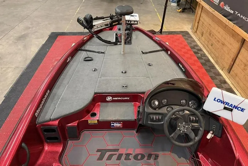 Slide: The Image of 2003 Triton Tr-186 boat interior with steering wheel, Lowrance system, and Mercury controls. - 5