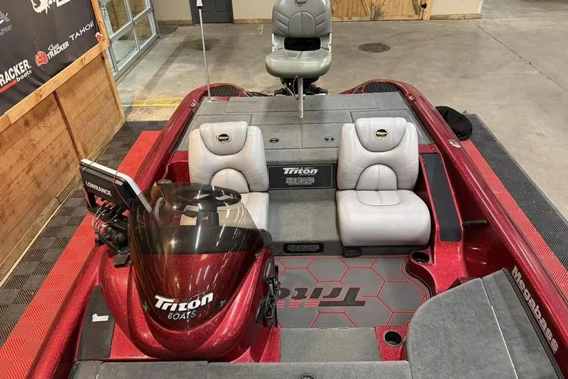 Slide: The Image of 2003 Triton Tr-186 boat interior with red accents and gray seating. - 8