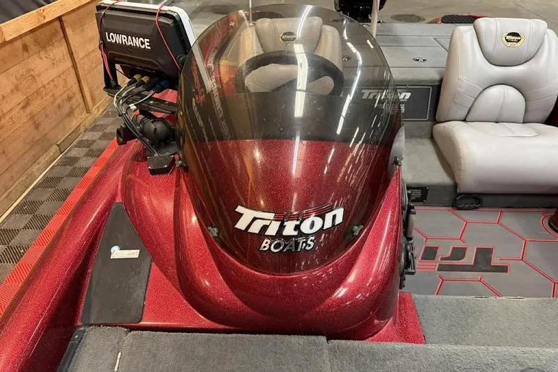 Slide: The Image of 2003 Triton Tr-186 boat interior with Lowrance equipment and Triton branding. - 9