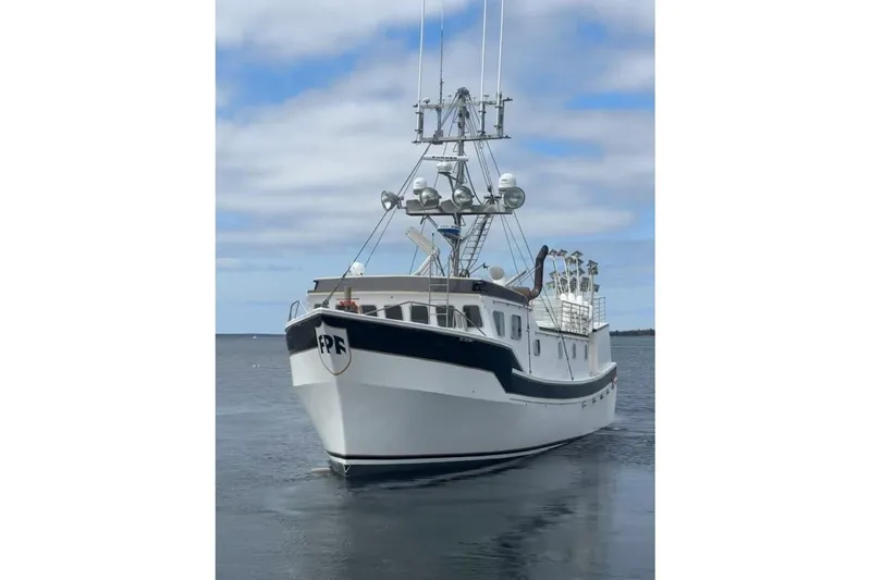 The Image of Commercial Long Liner boat from 1992 on calm water under a cloudy sky. - 0