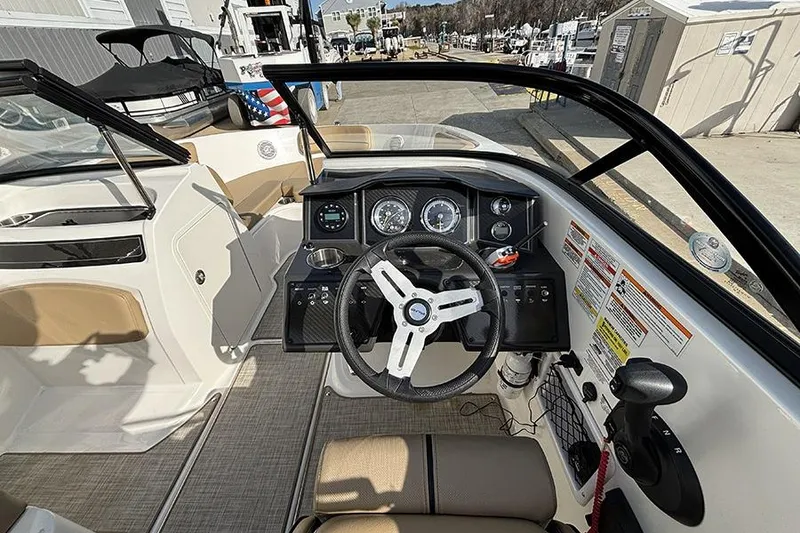 Slide: The Image of 2023 Bayliner VR5 Bowrider OB dashboard with steering wheel and control panel. - 16