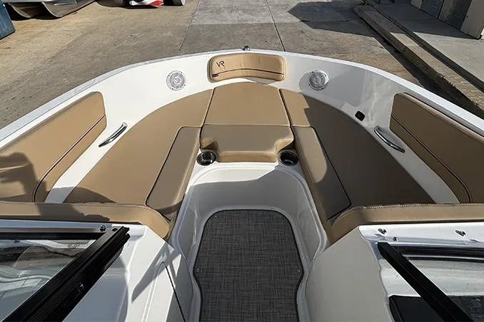Slide: The Image of 2023 Bayliner VR5 Bowrider OB interior with tan seating and spacious layout. - 21