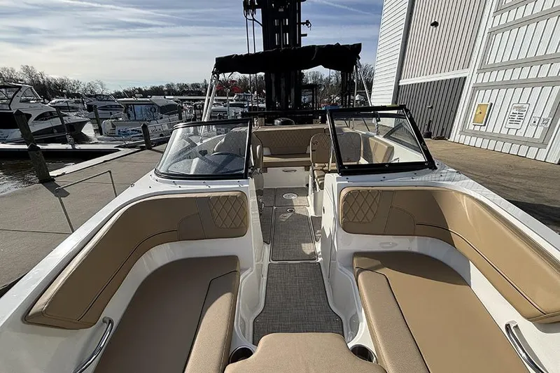 Slide: The Image of 2023 Bayliner VR5 Bowrider OB with tan seating, docked at a marina. - 24