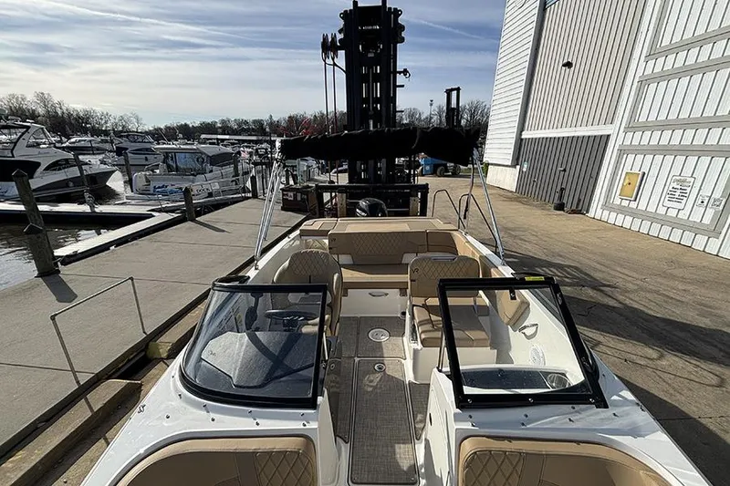 Slide: The Image of 2023 Bayliner VR5 Bowrider OB docked at marina, showcasing spacious interior and sleek design. - 25