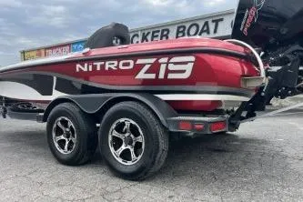 Slide: The Image of 2021 Nitro Z19 Pro boat on trailer, red and black design, parked outdoors. - 2