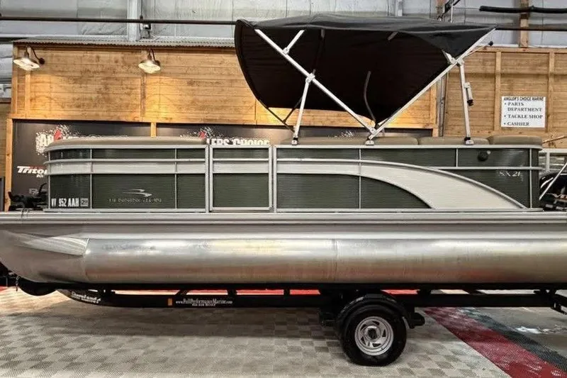The Image of 2018 Bennington 21 SLX pontoon boat with canopy in showroom. - 1