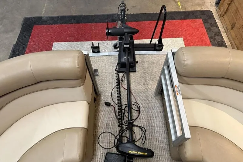 Slide: The Image of 2018 Bennington 21 SLX boat interior with beige seating and trolling motor. - 10