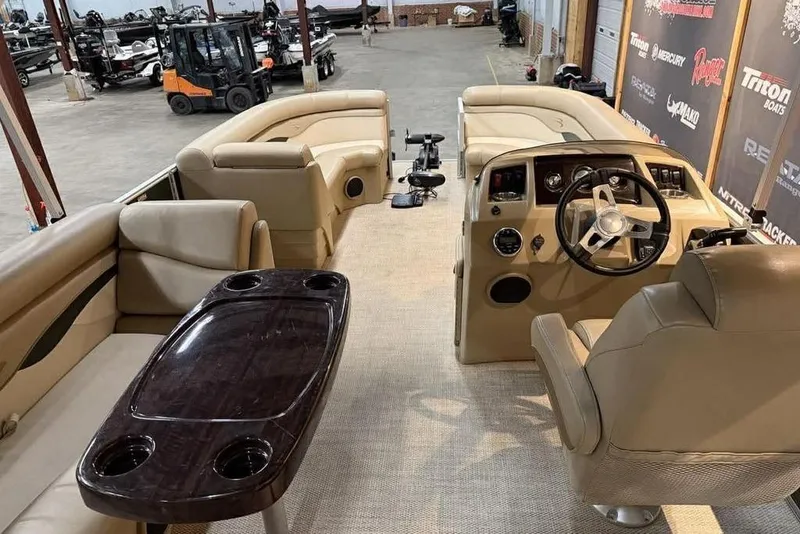 Slide: The Image of 2018 Bennington 21 SLX pontoon boat interior with beige seating and steering console. - 11