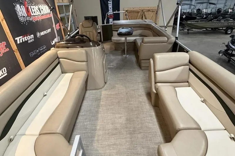 Slide: The Image of 2018 Bennington 21 SLX pontoon boat interior with beige seating and carpeted floor. - 12