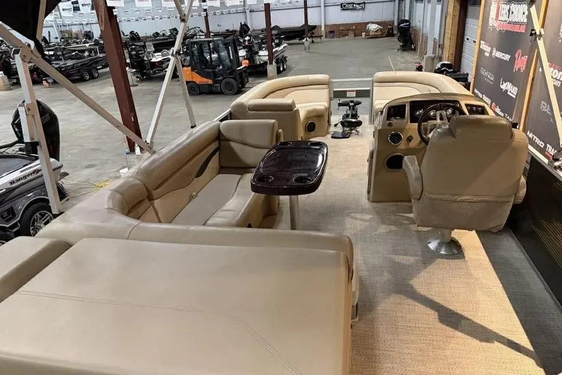 Slide: The Image of 2018 Bennington 21 SLX pontoon boat interior with beige seating and steering console. - 9