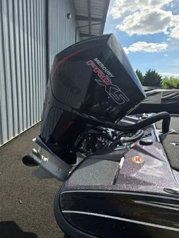 Slide: The Image of 2025 Bass Cat Lynx STS with Mercury Pro XS engine, parked outdoors. - 5