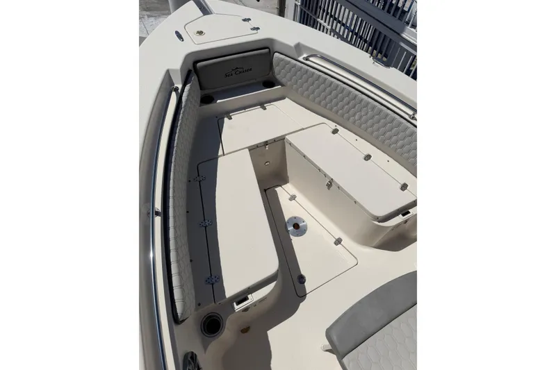 Slide: The Image of 2023 Sea Chaser 24 HFC boat interior with cushioned seating and storage compartments. - 11