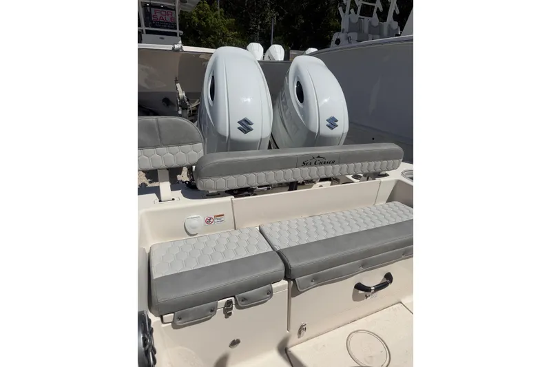 Slide: The Image of 2023 Sea Chaser 24 HFC boat with dual Suzuki engines and cushioned seating. - 13