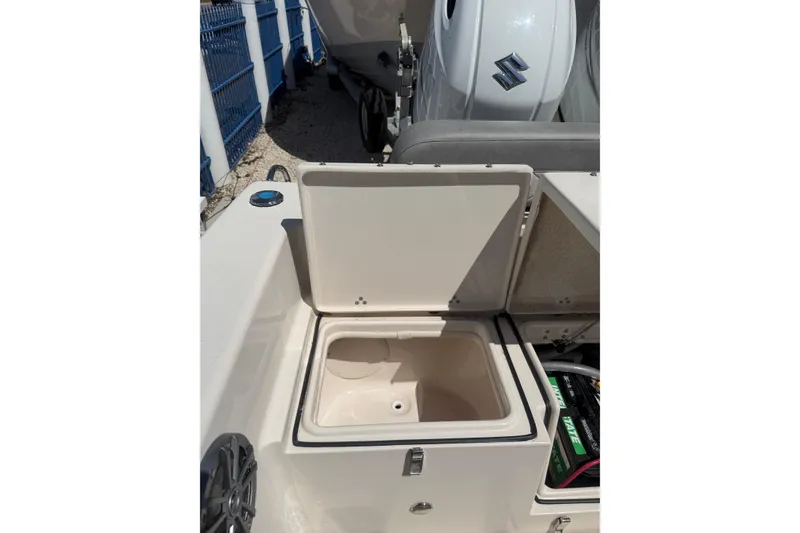 Slide: The Image of 2023 Sea Chaser 24 HFC boat with open storage compartment and visible engine. - 15