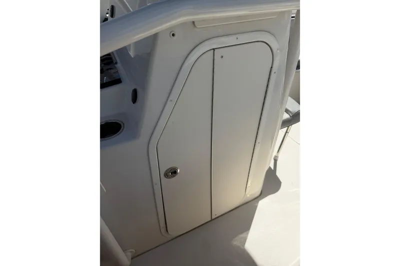 Slide: The Image of 2023 Sea Chaser 24 HFC boat console storage compartment with secure latch. - 16