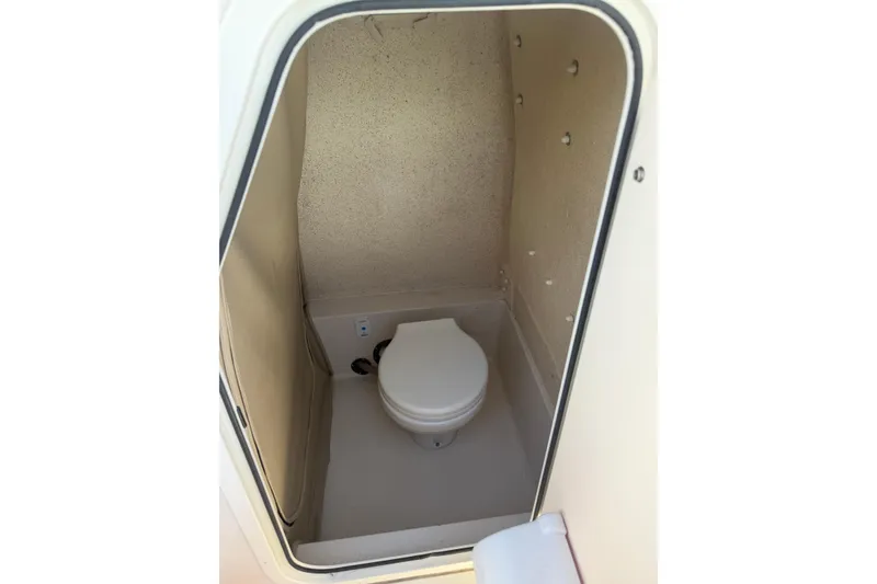 Slide: The Image of 2023 Sea Chaser 24 HFC boat interior with compact marine toilet. - 17