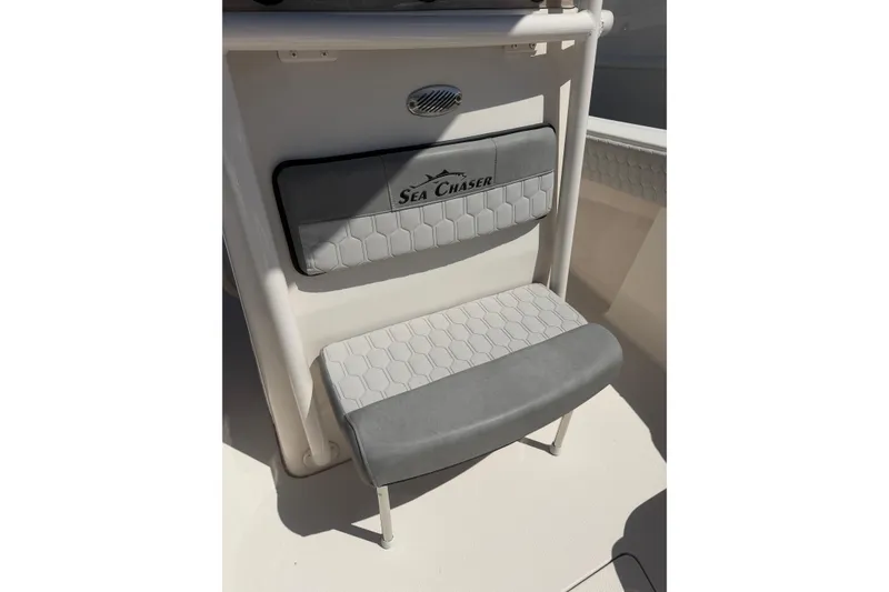 Slide: The Image of 2023 Sea Chaser 24 HFC boat seat with logo and hexagonal pattern. - 21
