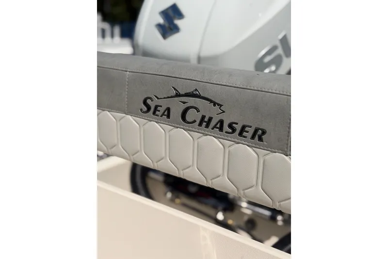 Slide: The Image of 2023 Sea Chaser 24 HFC boat interior detail with logo and textured upholstery. - 22
