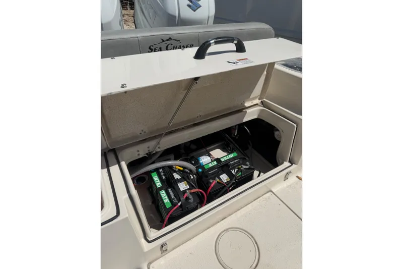 Slide: The Image of 2023 Sea Chaser 24 HFC boat battery compartment with open hatch. - 24