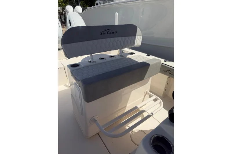 Slide: The Image of 2023 Sea Chaser 24 HFC boat seating with cup holders and footrest. - 8
