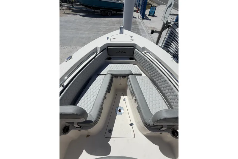 Slide: The Image of 2023 Sea Chaser 24 HFC boat interior with cushioned seating and storage compartments. - 9