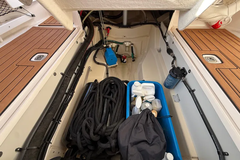 Slide: The Image of 2022 Ranger Tugs R-27 storage compartment with ropes and maintenance supplies. - 28