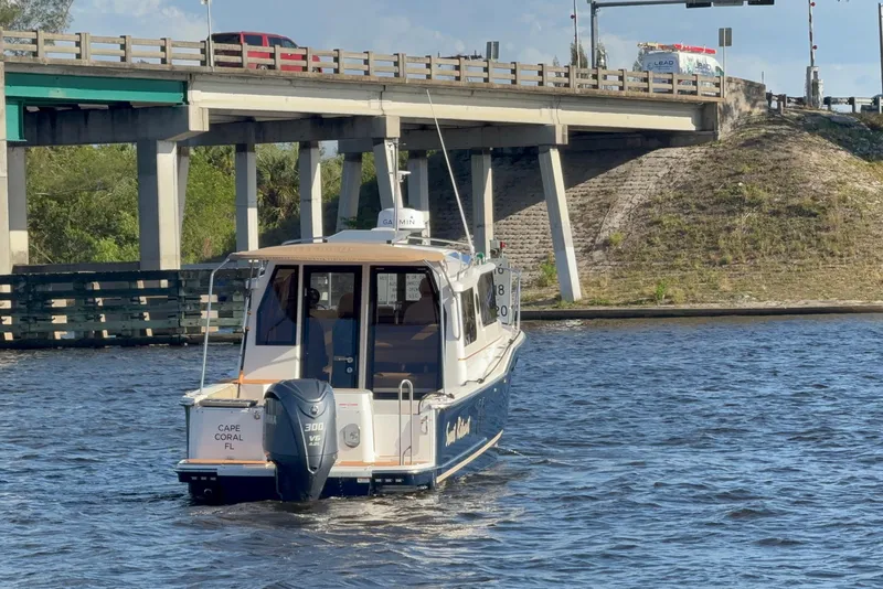 Slide: The Image of 2022 Ranger Tugs R-27 boat cruising under a bridge in Cape Coral, Florida. - 3